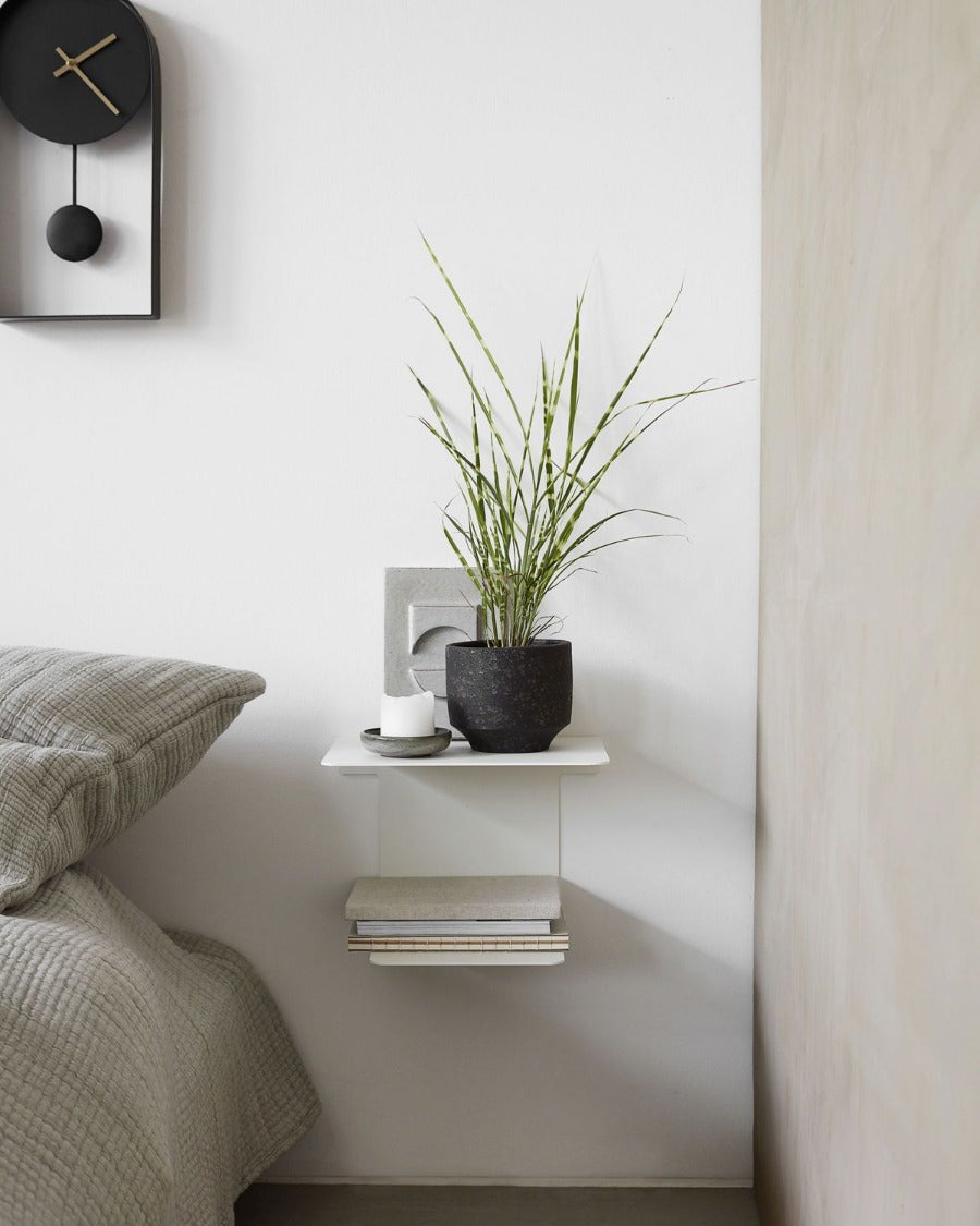 Book is a steel shelf with a white coating that blends in nicely in any home décor. You can place books and magazines on the bottom shelf and create a personal look with a vase, candle holder or small table lamp on the top shelf. Hang Book by your bed as a bedside table, or in your living room to showcase your favourite items