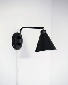 stunning wall light that is made with a modern style in mind. The black lamp is made of iron, which adds character and personality to the look. Hang the light in your bedroom as a decorative bedside lamp, or hang it on the wall in your living room as an exciting and new source of light.
