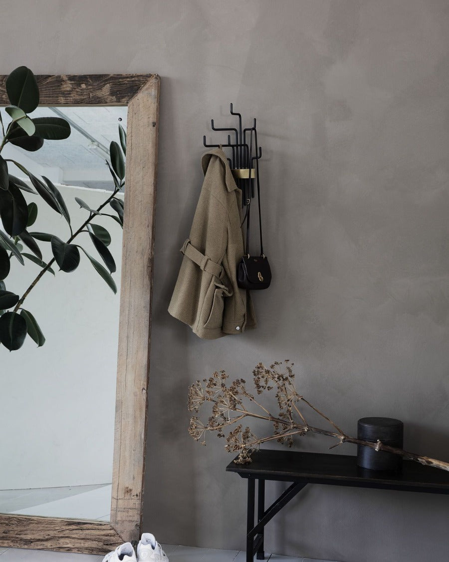 Stylishly designed coat rack fits perfectly in the hallway, but you can also use it in the bedroom or wardrobe. The black hooks of different heights are movable and look like bound together with golden detail.